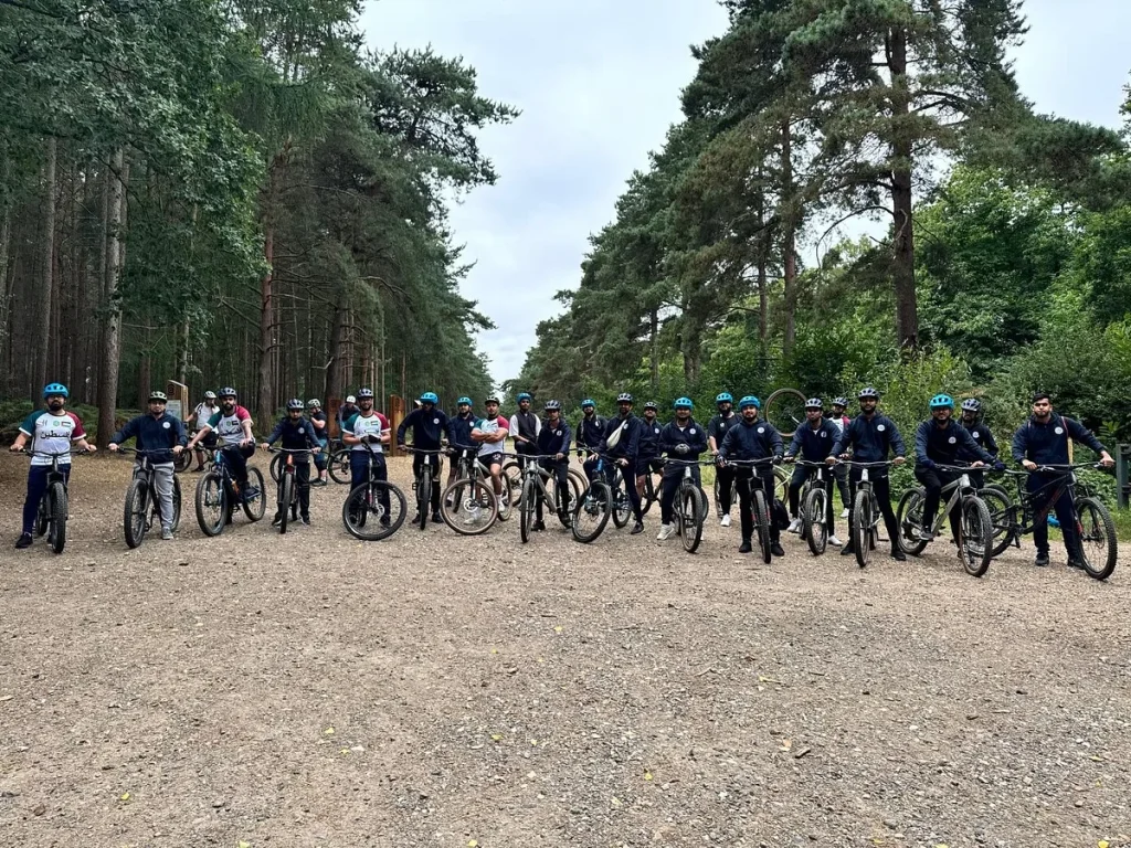 Roots Foundation Trust cycling trek team with bikes in the forest